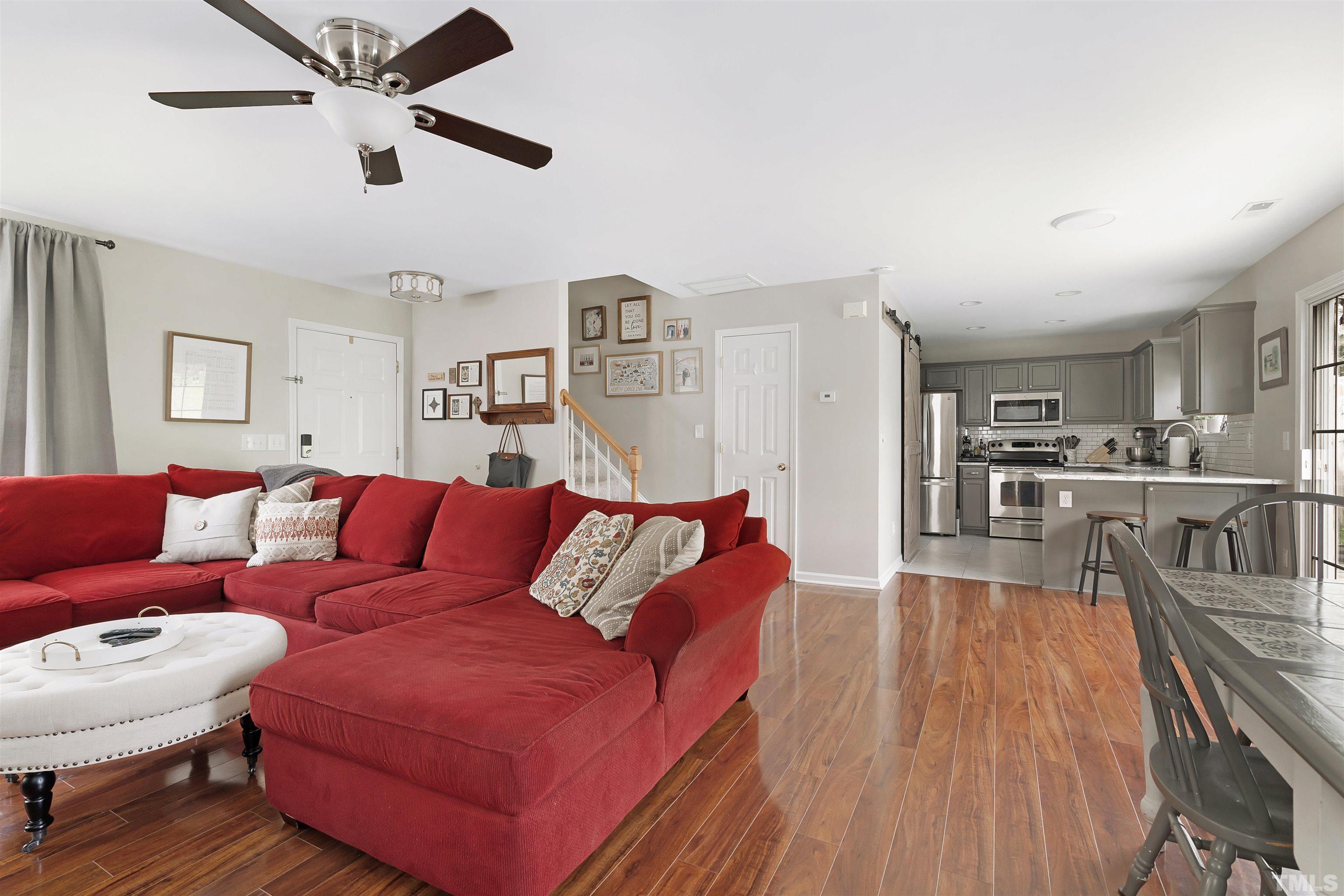 12440 North Exeter Way Durham, NC 27703 - Photo 20 of 36 a living room with furniture and a wooden floor