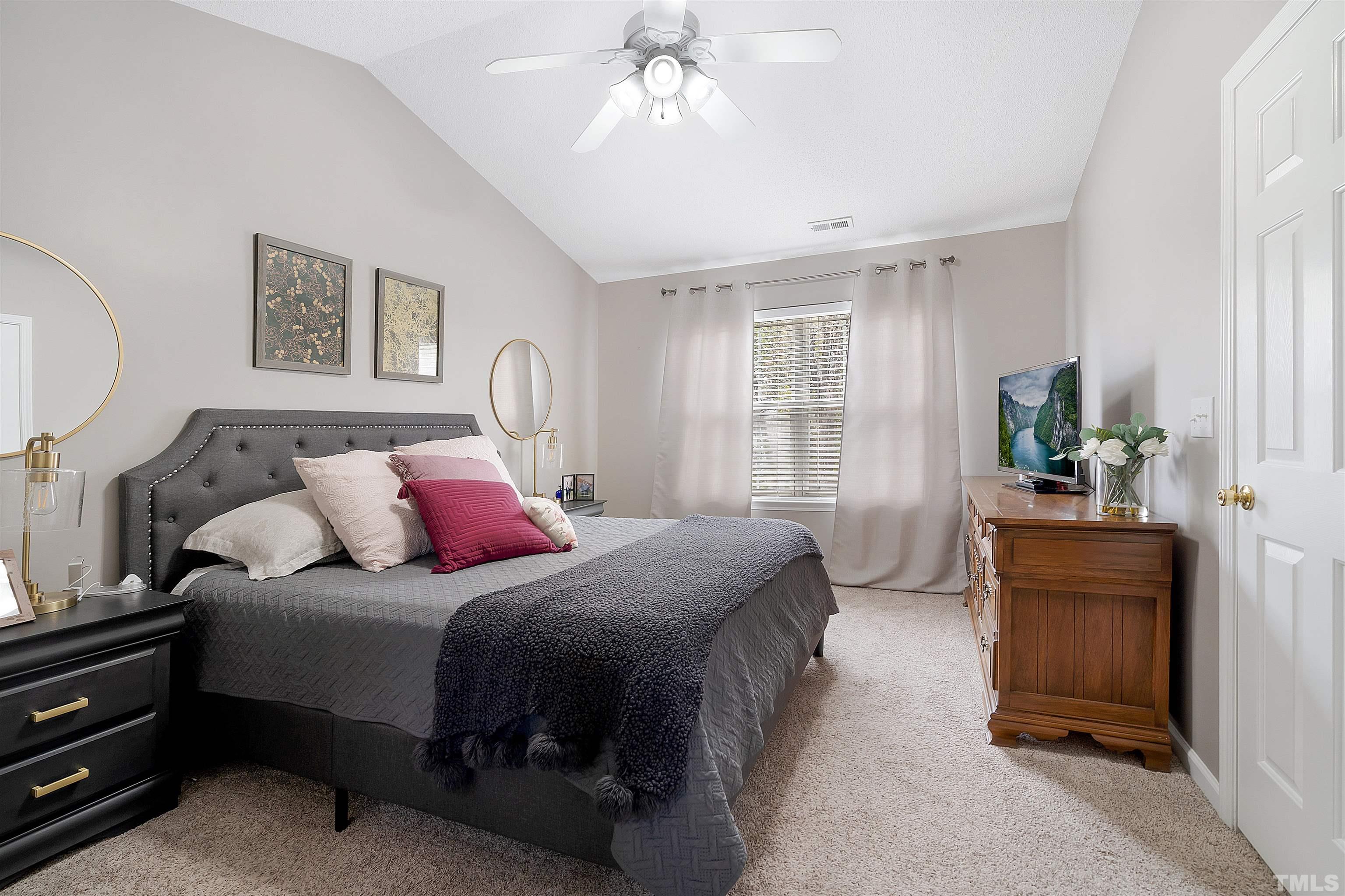 12440 North Exeter Way Durham, NC 27703 - Photo 21 of 36 a bedroom with a bed and a chandelier