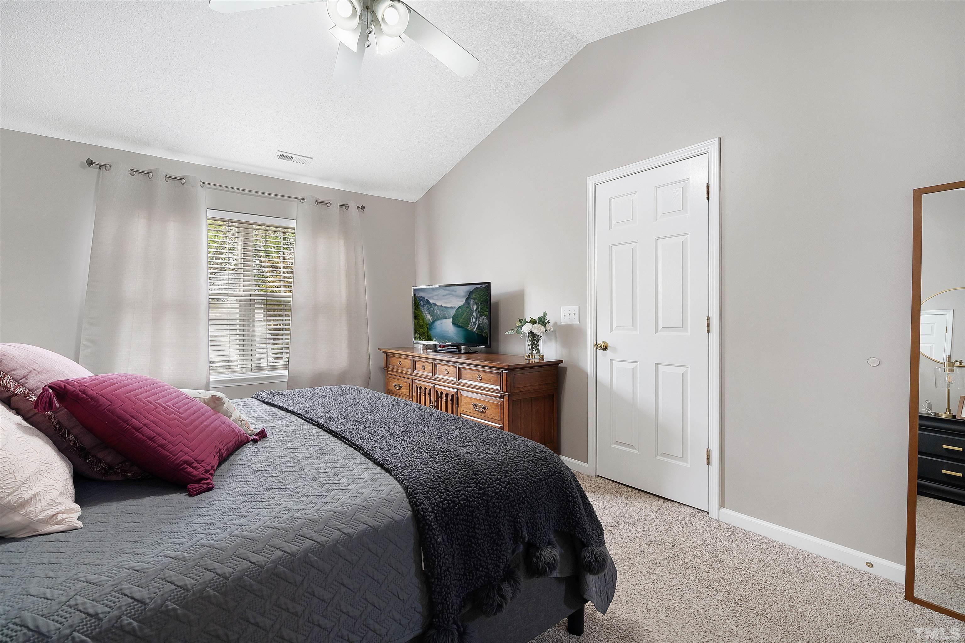 12440 North Exeter Way Durham, NC 27703 - Photo 22 of 36 a bedroom with a bed and a television