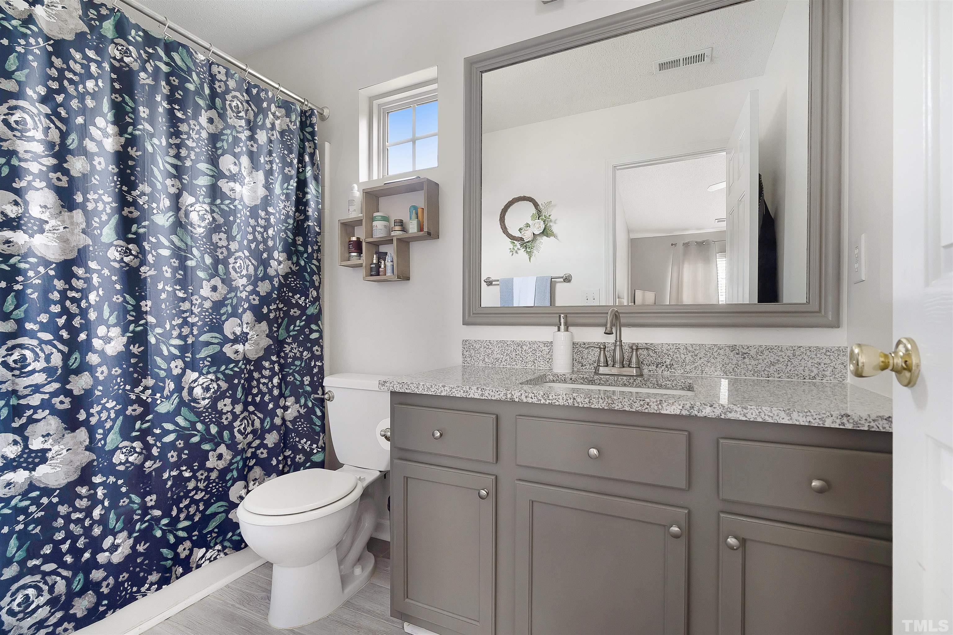 12440 North Exeter Way Durham, NC 27703 - Photo 23 of 36 a bathroom with a granite countertop bathtub sink vanity mirror and toilet