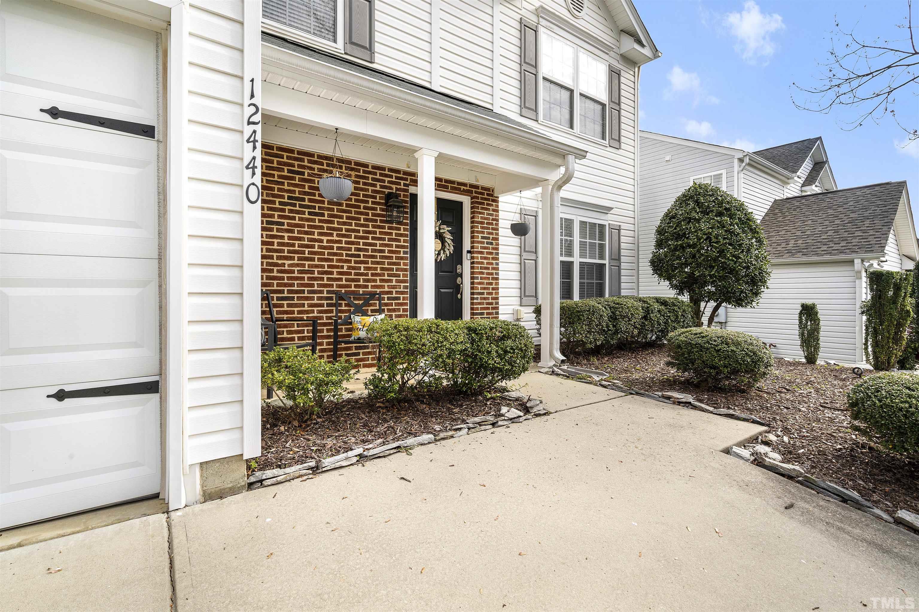 12440 North Exeter Way Durham, NC 27703 - Photo 3 of 36 a front view of a house with a yard