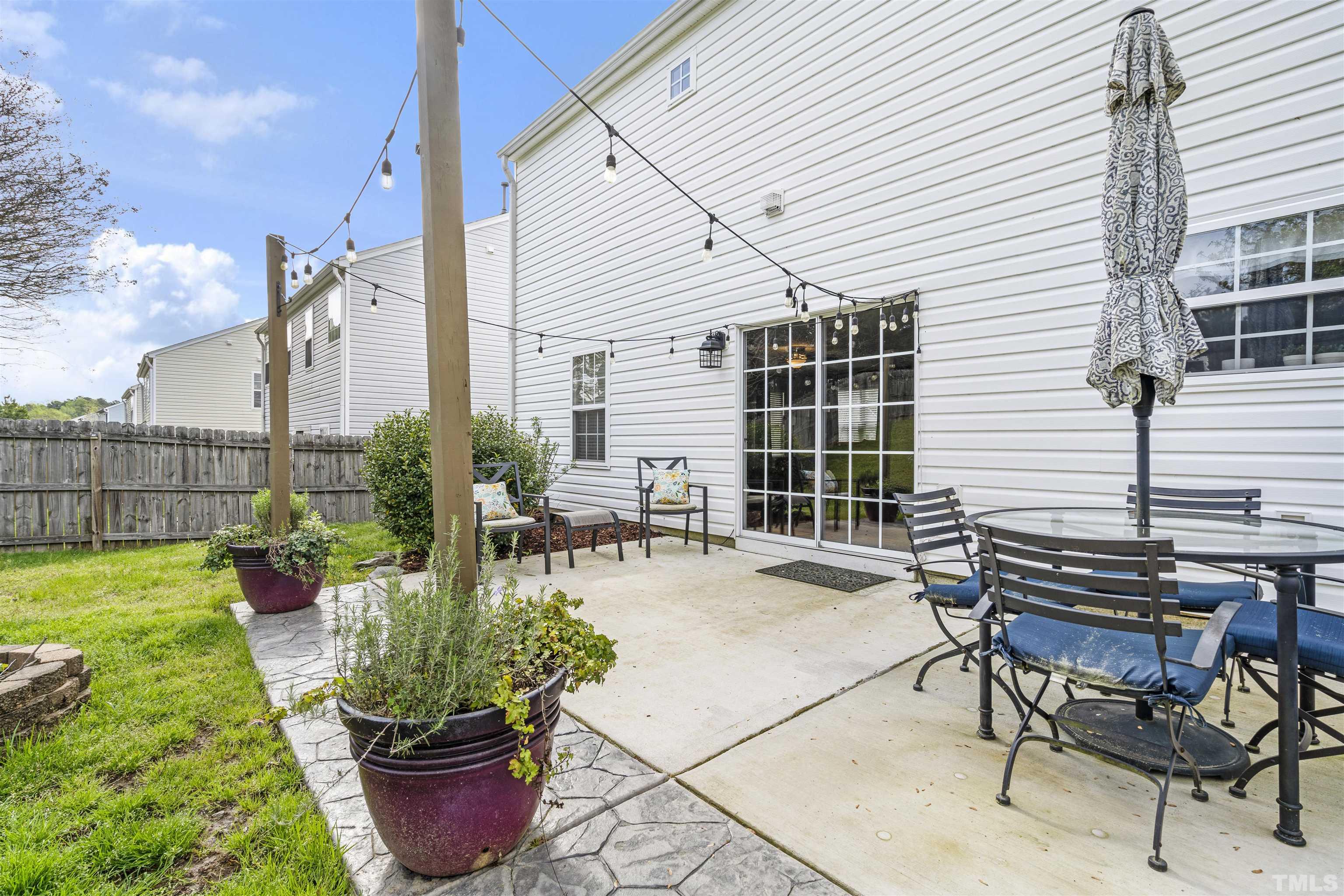 12440 North Exeter Way Durham, NC 27703 - Photo 32 of 36 a view of a patio with table and chairs and potted plants