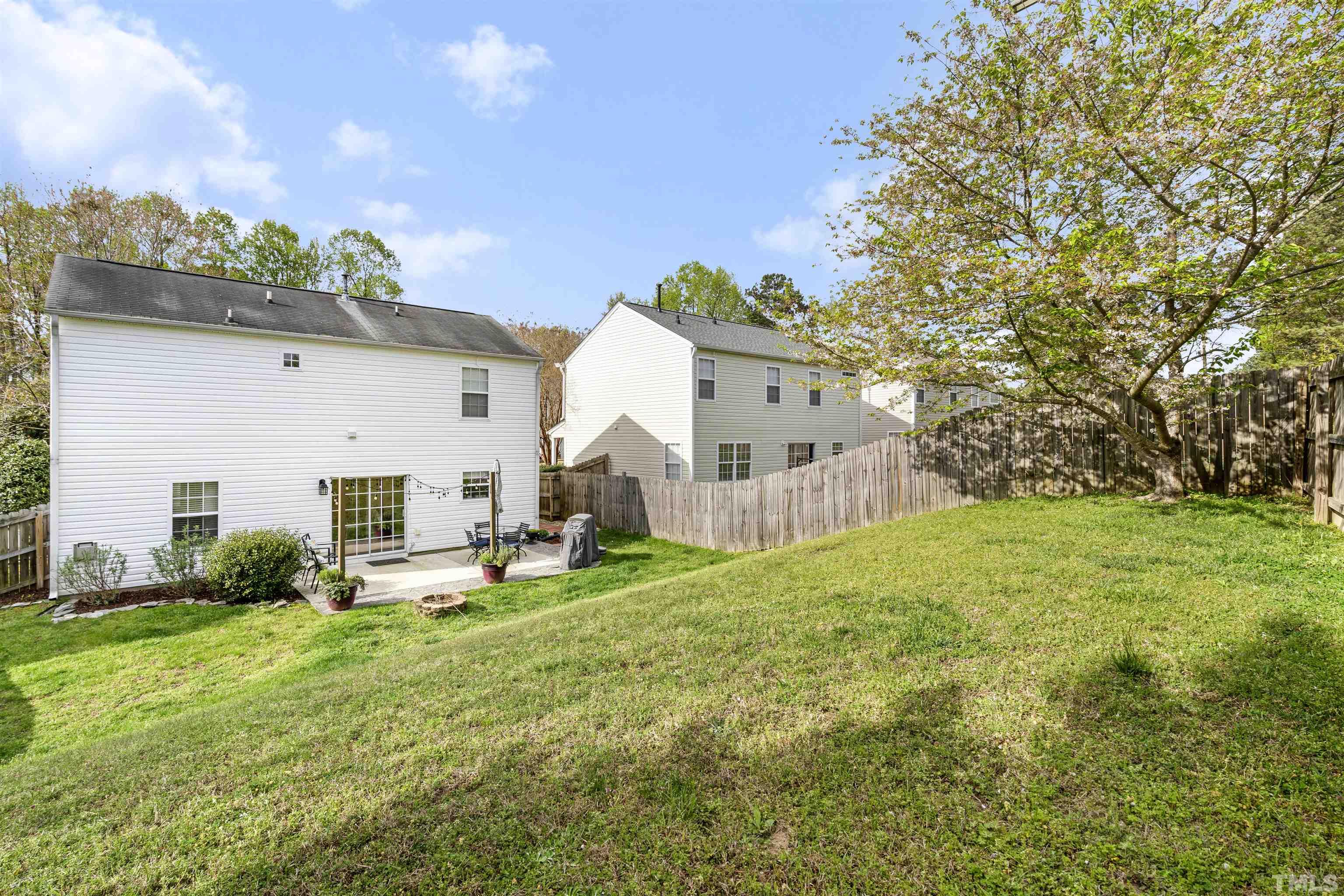 12440 North Exeter Way Durham, NC 27703 - Photo 35 of 36 a view of a house with a backyard and sitting area