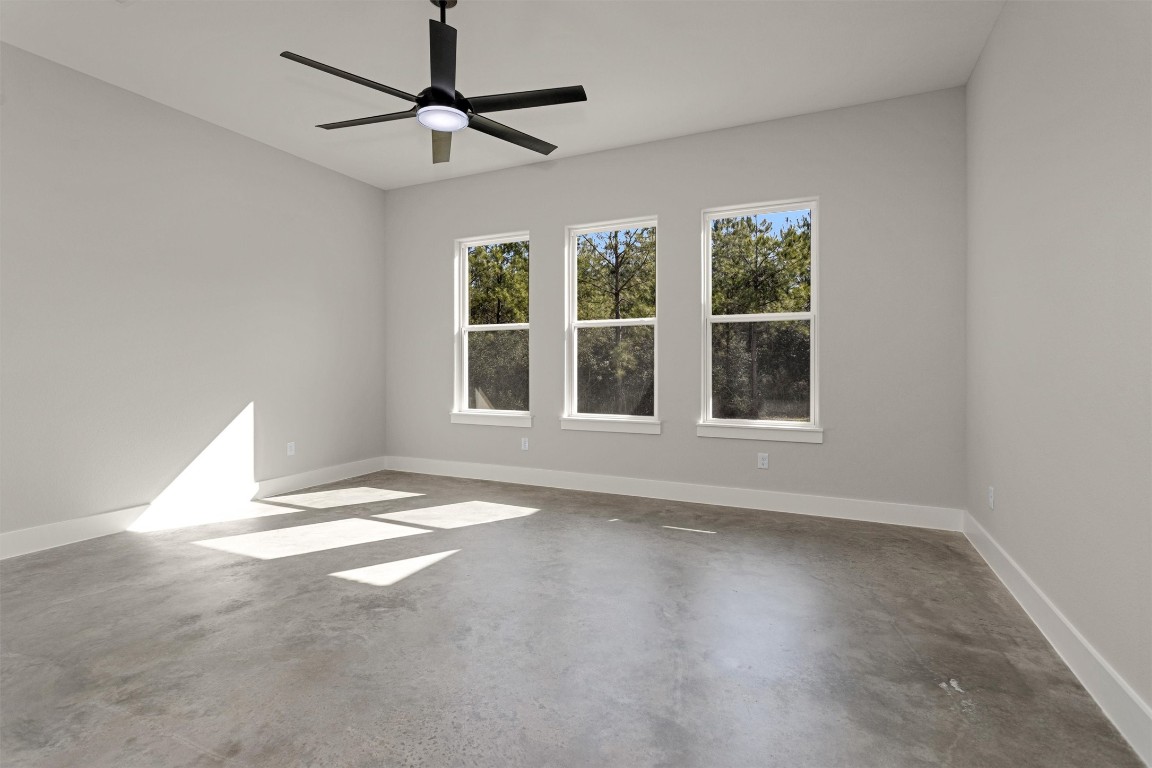 12744 Oak Barrel Road Willis, TX 77378 - Photo 21 of 50 The spacious primary bedroom offers a peaceful retreat with plenty of room to relax and unwind. Large windows frame serene views of the backyard, allowing natural light to pour in while creating a calm, airy atmosphere.
Designed for comfort and privacy, the suite seamlessly connects to a well-appointed en suite bath, providing a private sanctuary to start and end your day. This inviting space perfectly balances size, light, and functionality for everyday living.