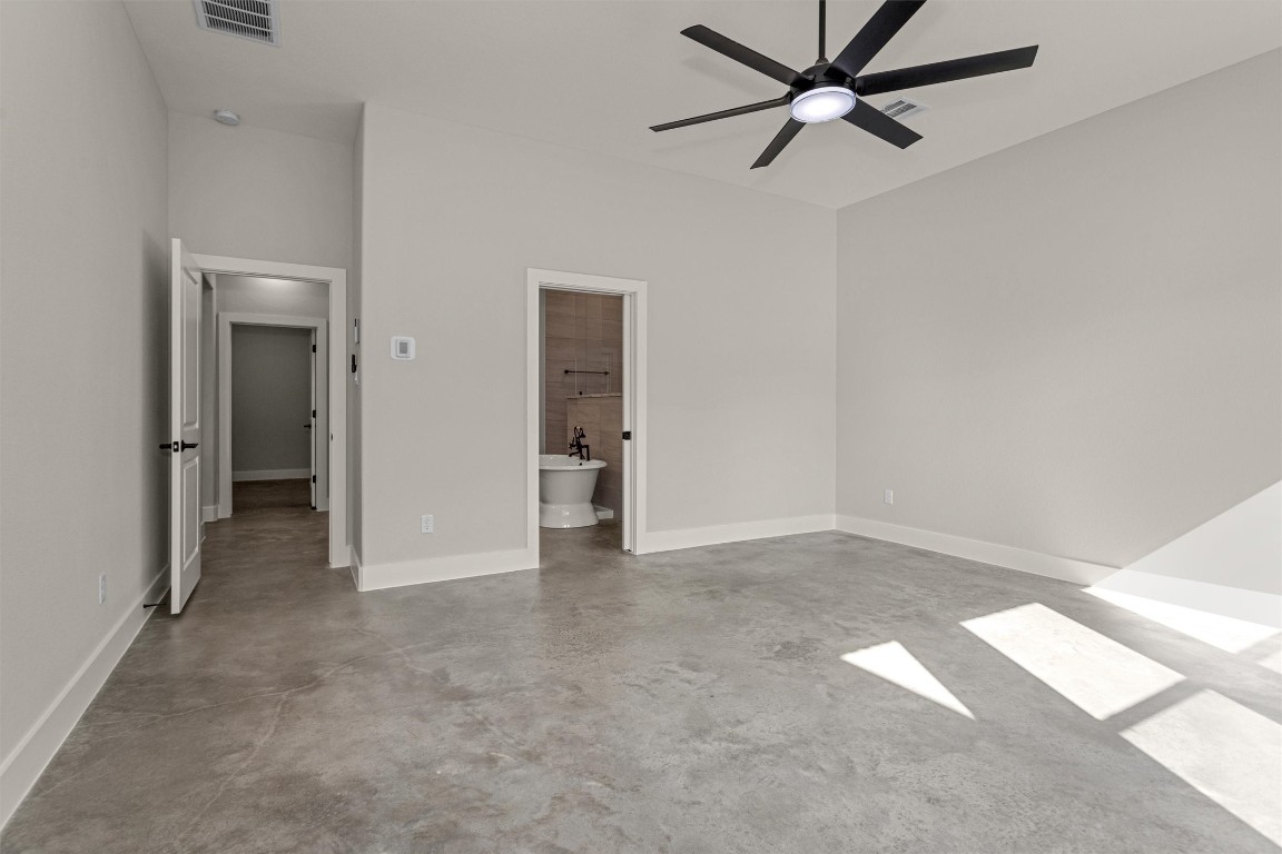 12744 Oak Barrel Road Willis, TX 77378 - Photo 22 of 50 The spacious primary bedroom offers a peaceful retreat with plenty of room to relax and unwind. Large windows frame serene views of the backyard, allowing natural light to pour in while creating a calm, airy atmosphere.
Designed for comfort and privacy, the suite seamlessly connects to a well-appointed en suite bath, providing a private sanctuary to start and end your day. This inviting space perfectly balances size, light, and functionality for everyday living.