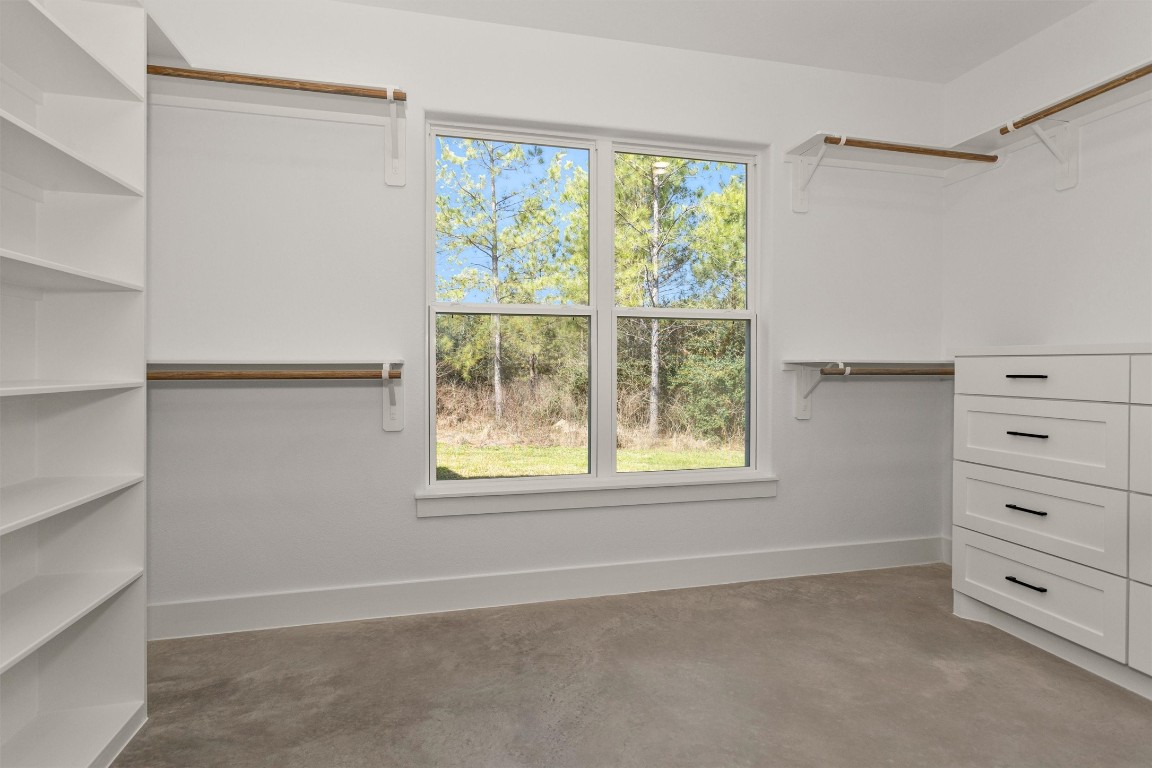 12744 Oak Barrel Road Willis, TX 77378 - Photo 28 of 50 The spacious primary closet is thoughtfully designed with built-in shelving and drawers, providing abundant storage and organization for every wardrobe need.