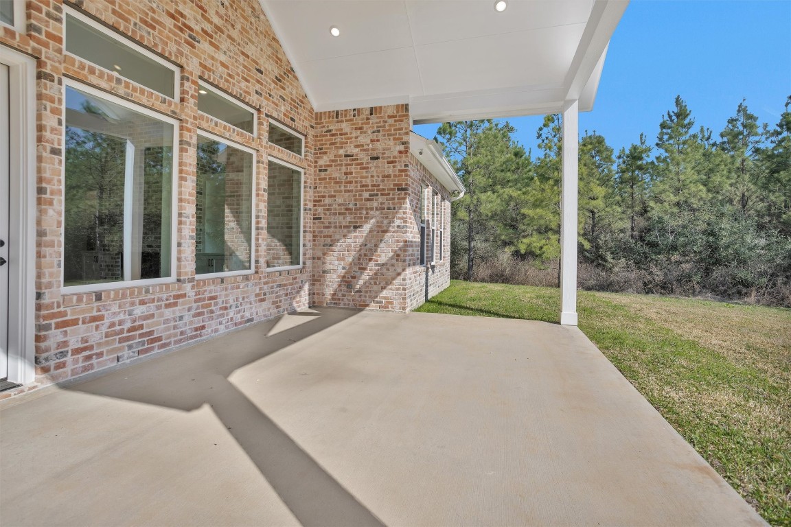 12744 Oak Barrel Road Willis, TX 77378 - Photo 39 of 50 The large covered back patio offers the perfect outdoor extension of the home, providing a shaded and comfortable space to relax or entertain year-round. With plenty of room for seating, dining, or an outdoor kitchen setup, this area is a true blank canvas ready for your personal touch.