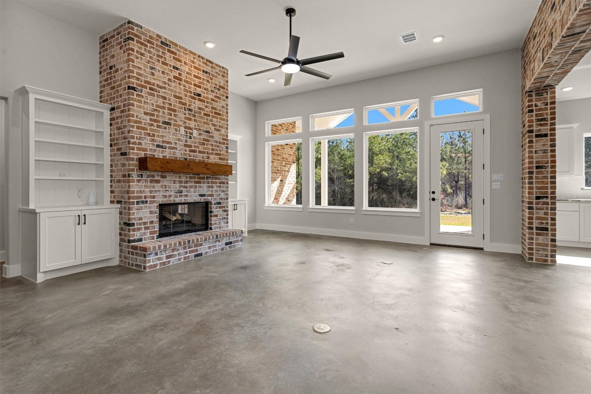 12744 Oak Barrel Road Willis, TX 77378 - Photo 7 of 50 Large, open windows flood the space with natural light while offering peaceful views of the backyard and its mature trees. The seamless blend of indoor comfort and outdoor scenery creates a relaxing atmosphere, perfect for quiet evenings at home or gathering with family and friends.