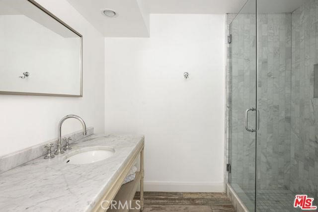 23760 Oakfield Road Hidden Hills, CA 91302 - Photo 13 of 23 a bathroom with a granite countertop sink and a mirror