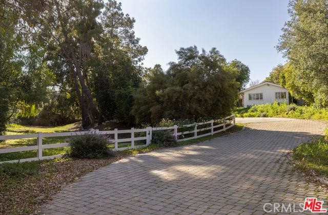 23760 Oakfield Road Hidden Hills, CA 91302 - Photo 14 of 23 a view of a bench in front of a house