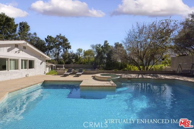 23760 Oakfield Road Hidden Hills, CA 91302 - Photo 22 of 23 a view of a house with swimming pool and sitting area