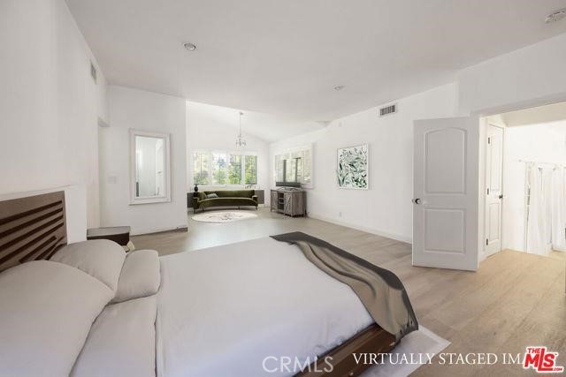 23760 Oakfield Road Hidden Hills, CA 91302 - Photo 6 of 23 a bed room with a bed and mirror