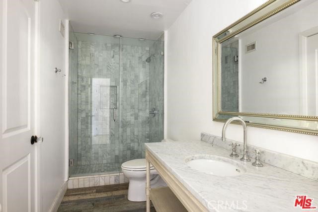 23760 Oakfield Road Hidden Hills, CA 91302 - Photo 8 of 23 a bathroom with a granite countertop sink toilet and shower