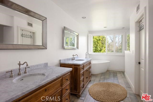 23760 Oakfield Road Hidden Hills, CA 91302 - Photo 10 of 23 a bathroom with a granite countertop sink a toilet and mirror