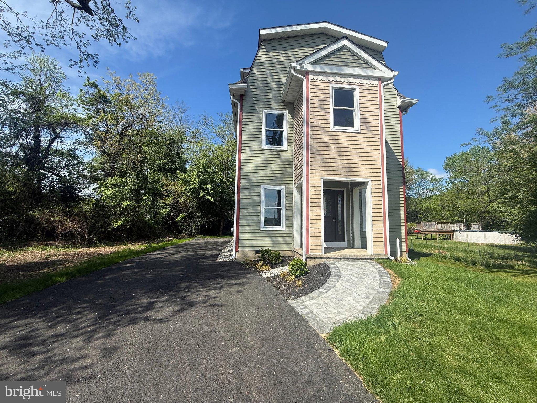 6416 Edesville Road Rock Hall, MD 21661 - Photo 2 of 43 Charming two-story home with lush greenery.
