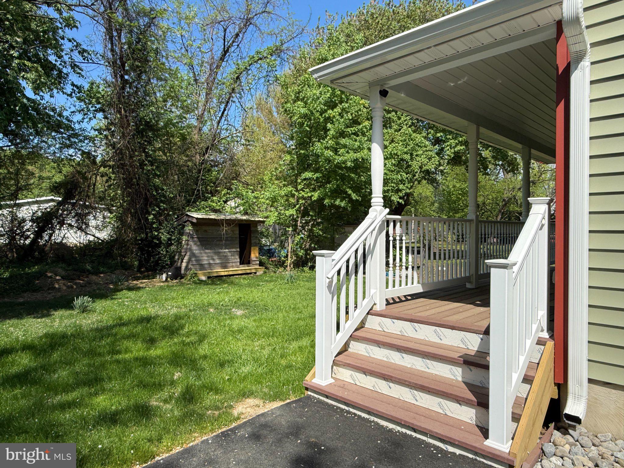 6416 Edesville Road Rock Hall, MD 21661 - Photo 42 of 43 Charming porch with lush greenery.