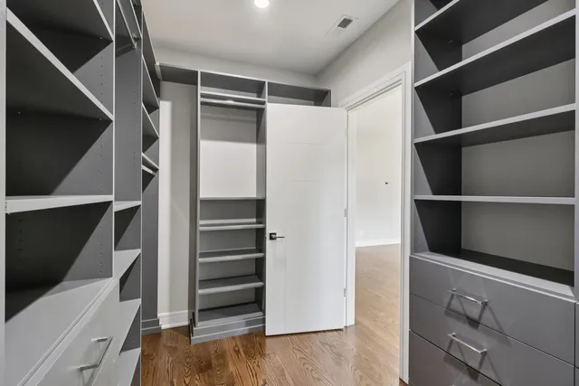 a view of walk in closet with empty racks