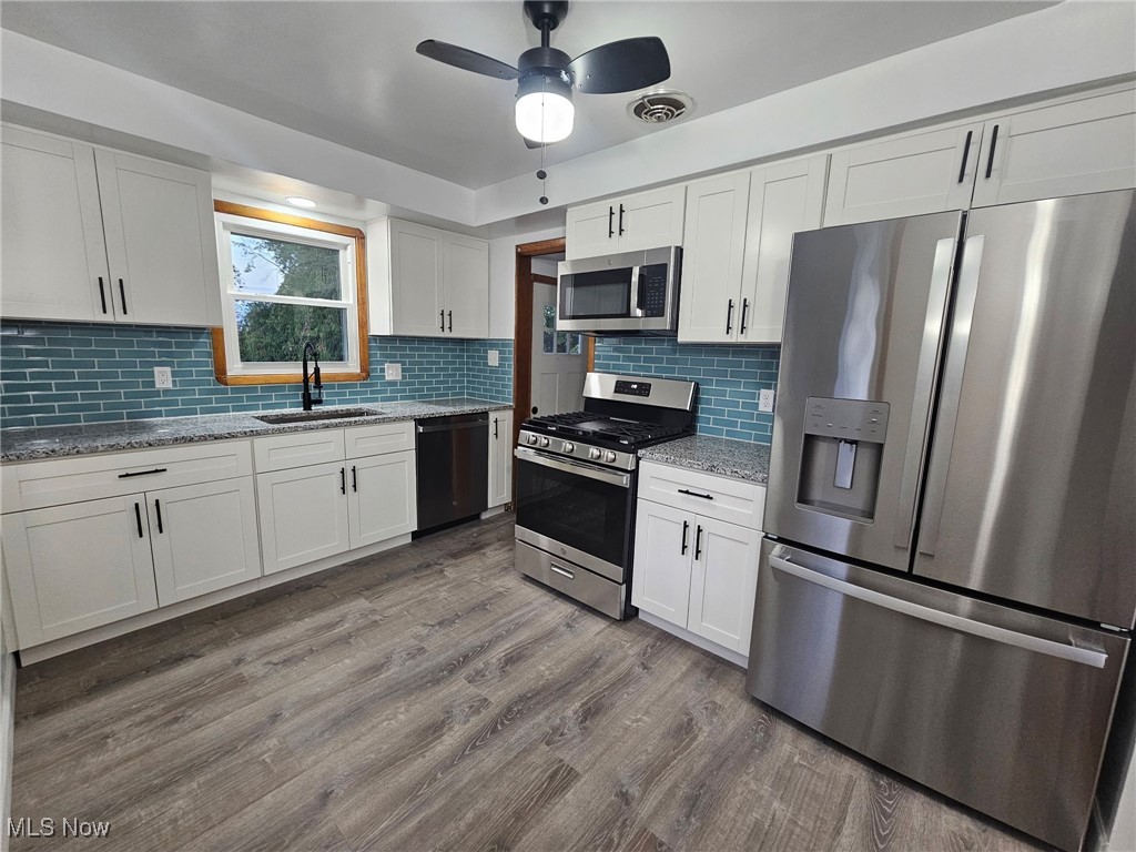3200 Dentzler Road Parma, OH 44134 - Photo 3 of 32 Kitchen with appliances with stainless steel finishes, white cabinets, and granite counters
