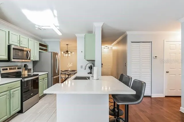 a kitchen with kitchen island a sink table and chairs