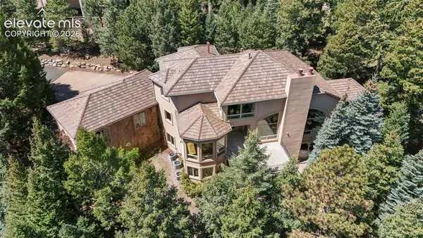 an aerial view of a house with yard and outdoor seating