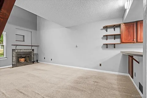 a room with a sink cabinets and a mirror