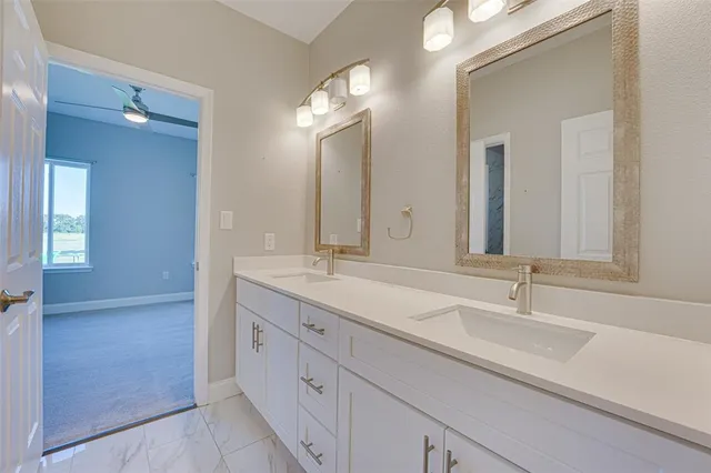 a bathroom with a double vanity sink and a mirror