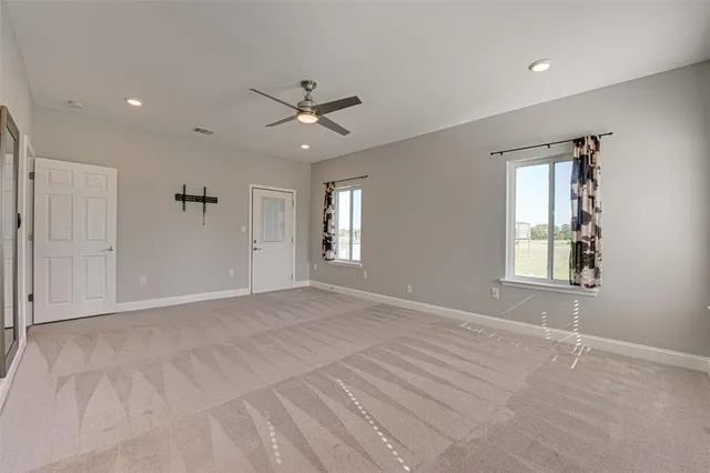 a bathroom with a granite countertop sink a toilet a mirror and bathtub