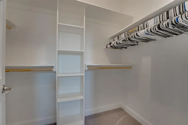 a spacious bathroom with a double vanity sink mirror and bathtub