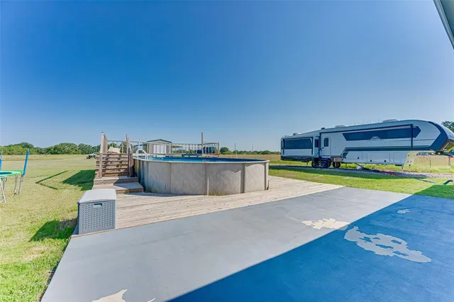 a house with yard and ocean view