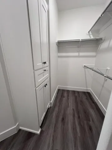 a view of a room with wooden floor