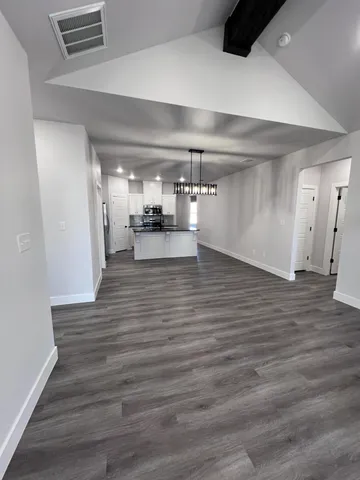 a view of a room with wooden floor