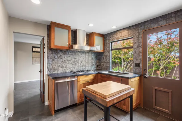 a kitchen with a stove a sink and a refrigerator