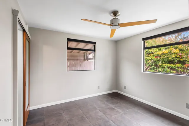 an empty room with windows and entrance