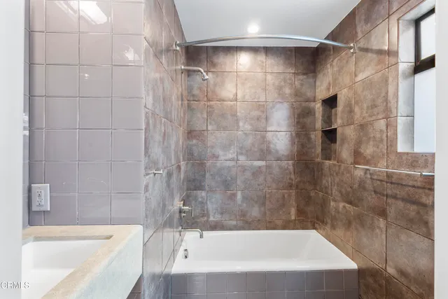a bathroom with a bathtub and a shower