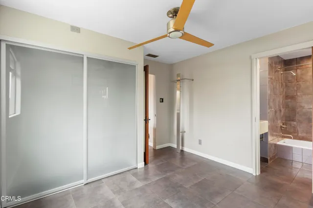a view of a big room with wooden floor and windows