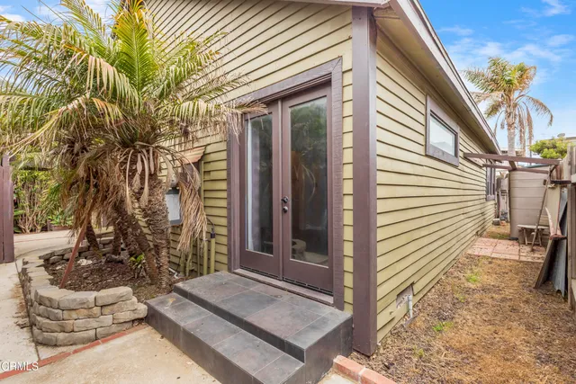 a view of house with backyard and outdoor seating