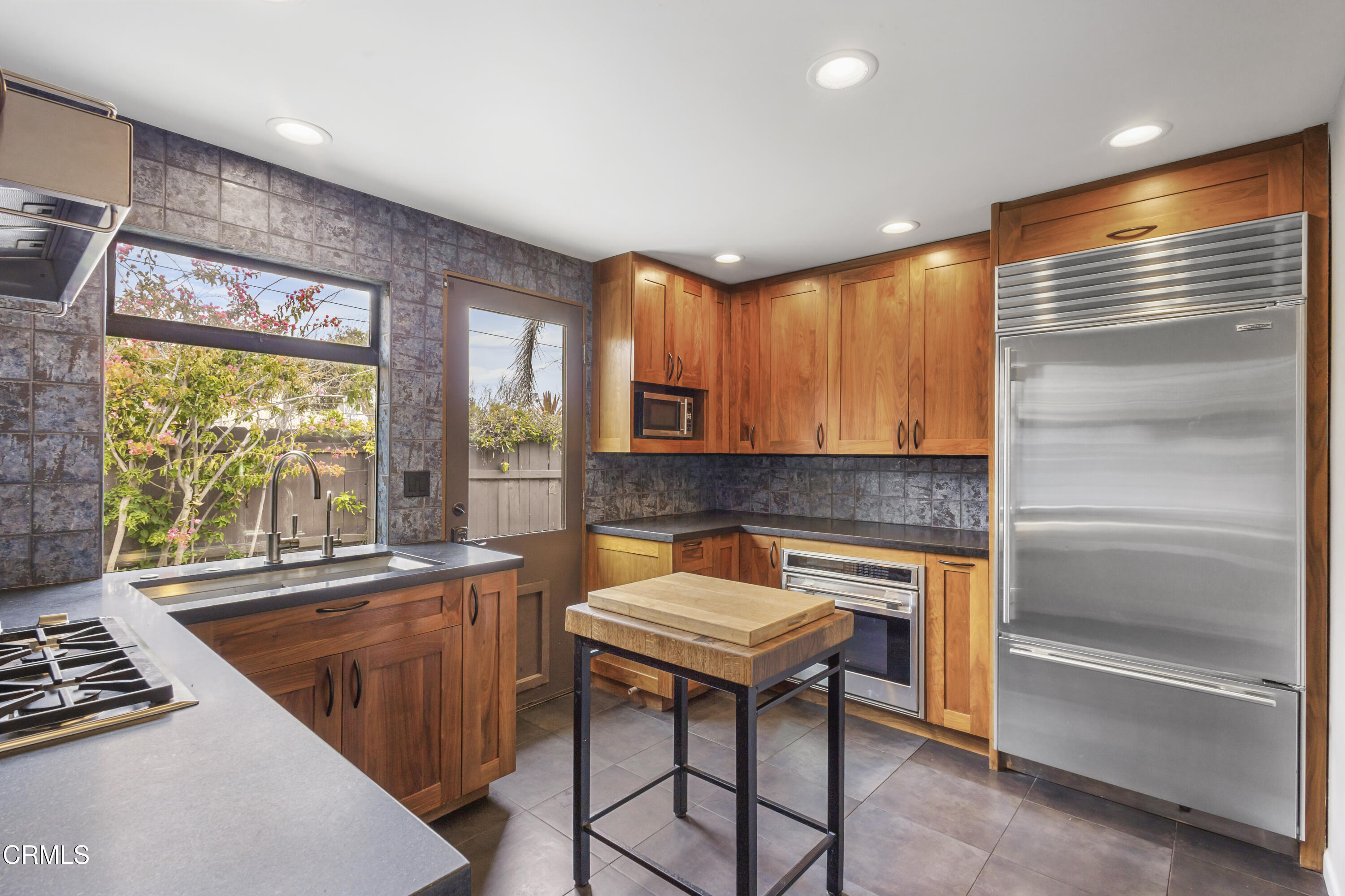 153 San Fernando Avenue Oxnard, CA 93035 - Photo 10 of 22 a kitchen with a refrigerator a sink and a stove top oven