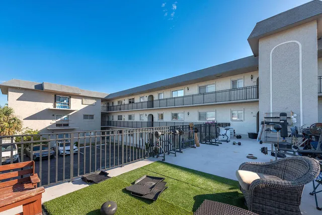 a view of a house with swimming pool and sitting area