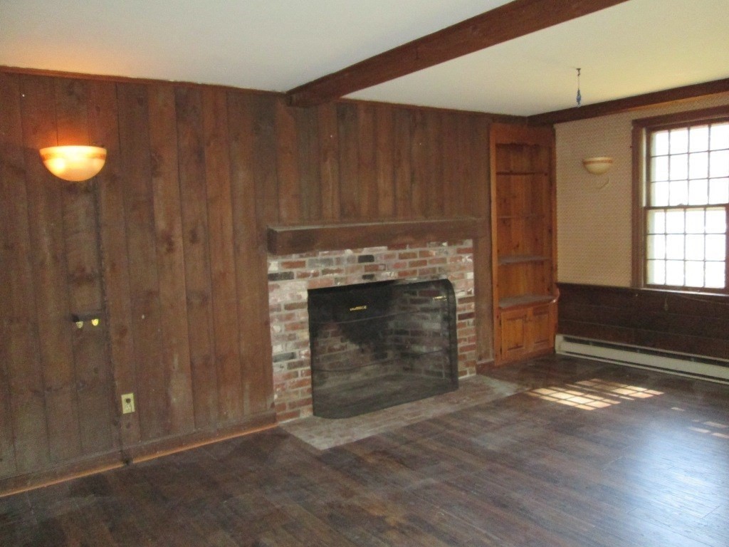 66 Westcott Road Harvard, MA 01451 - Photo 13 of 38 a view of an empty room with a fireplace and window