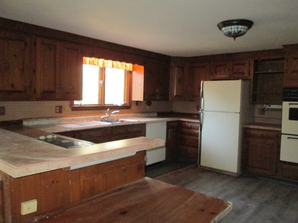 66 Westcott Road Harvard, MA 01451 - Photo 4 of 38 a kitchen with stainless steel appliances granite countertop a refrigerator a sink dishwasher a stove and white countertops with cabinets