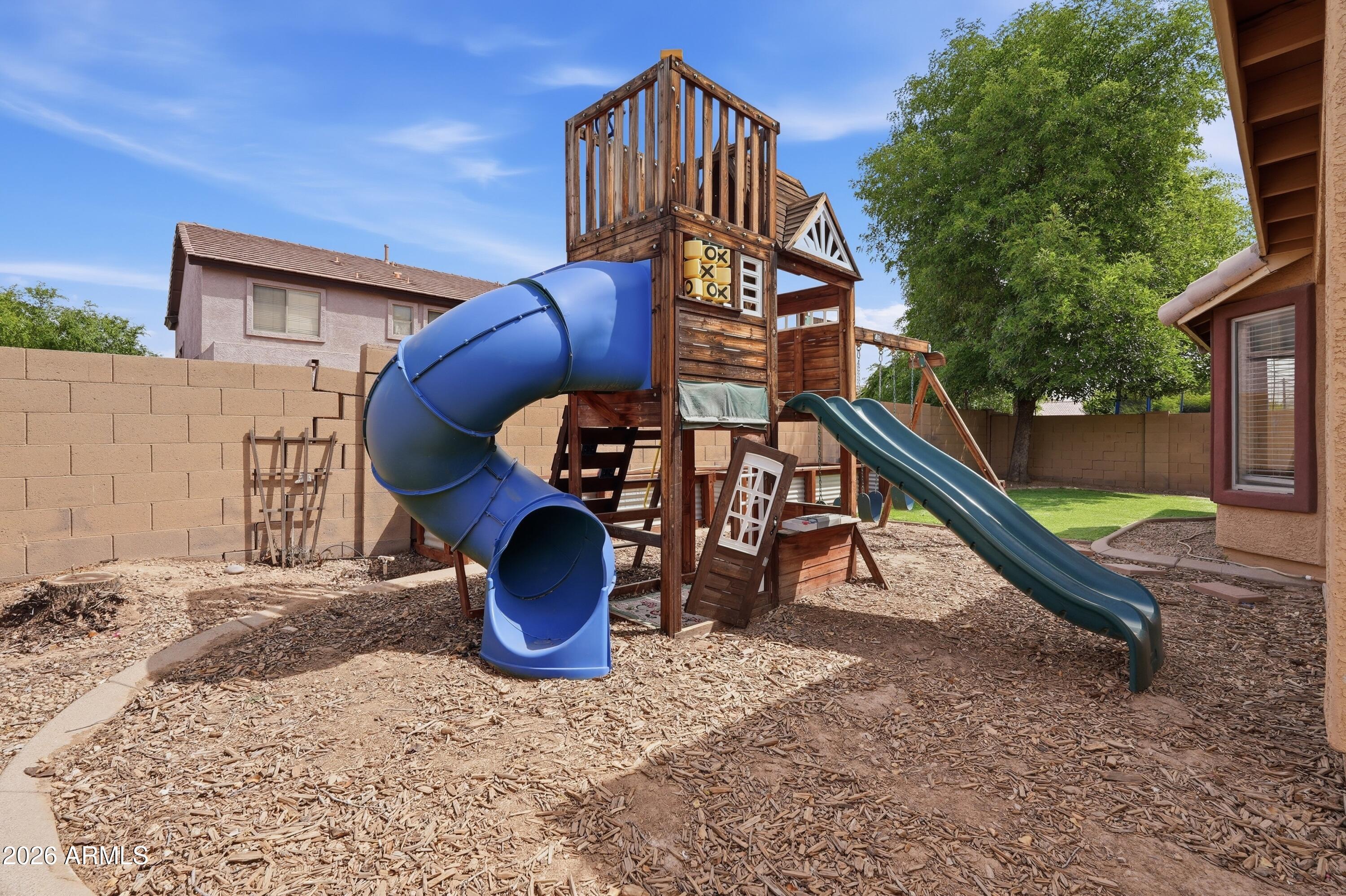3242 East Bonanza Road Gilbert, AZ 85297 - Photo 29 of 36 a backyard of a house with barbeque oven table and chairs