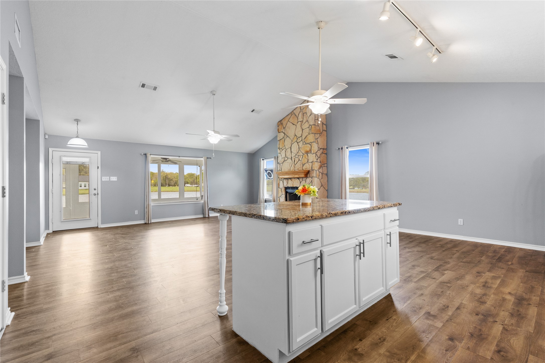 140 Meadowview Drive Trinity, TX 75862 - Photo 8 of 27 a kitchen with granite countertop a stove a sink and a chandelier