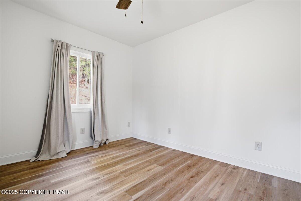 563 Pensyl Creek Road Stroudsburg, PA 18360 - Photo 102 of 143 an empty room with wooden floor and a window