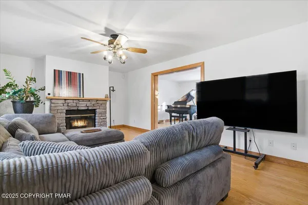 a kitchen with stainless steel appliances granite countertop a sink a stove cabinets and wooden floor