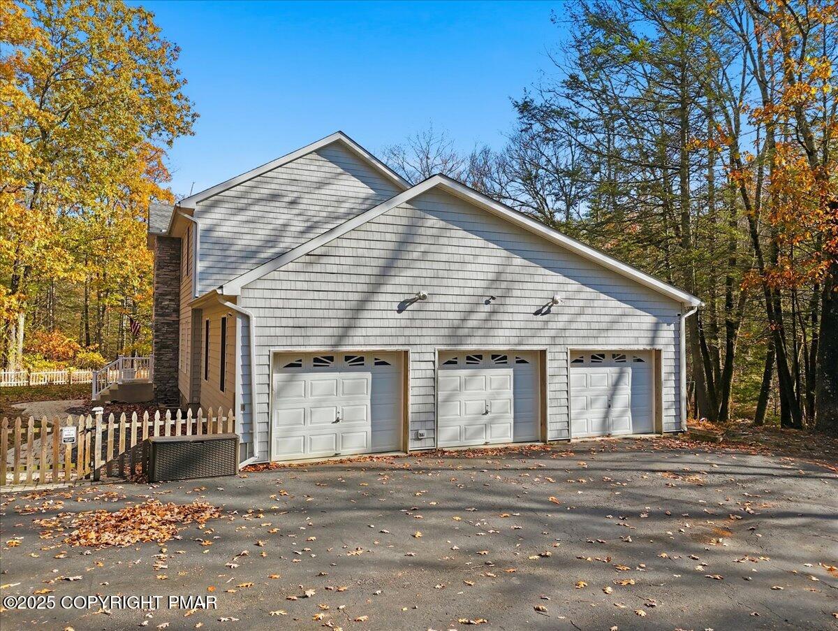 563 Pensyl Creek Road Stroudsburg, PA 18360 - Photo 121 of 143 a view of a house with a yard and garage