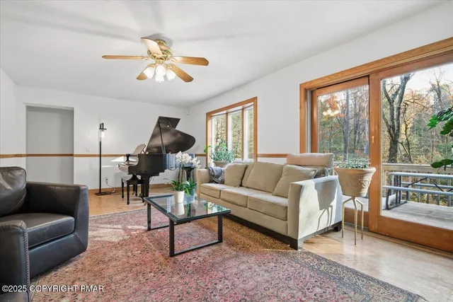 a living room with furniture a window and a flat screen tv