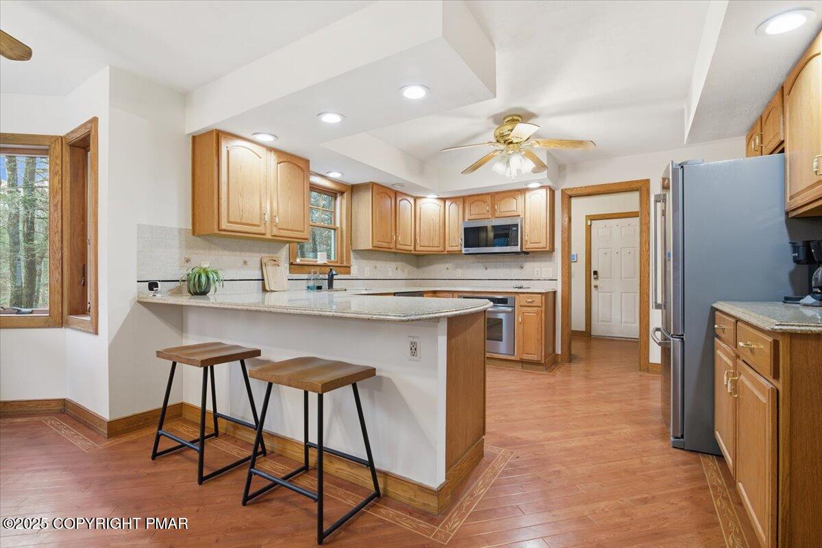 563 Pensyl Creek Road Stroudsburg, PA 18360 - Photo 23 of 143 a kitchen with stainless steel appliances granite countertop counter space a sink refrigerator and cabinets