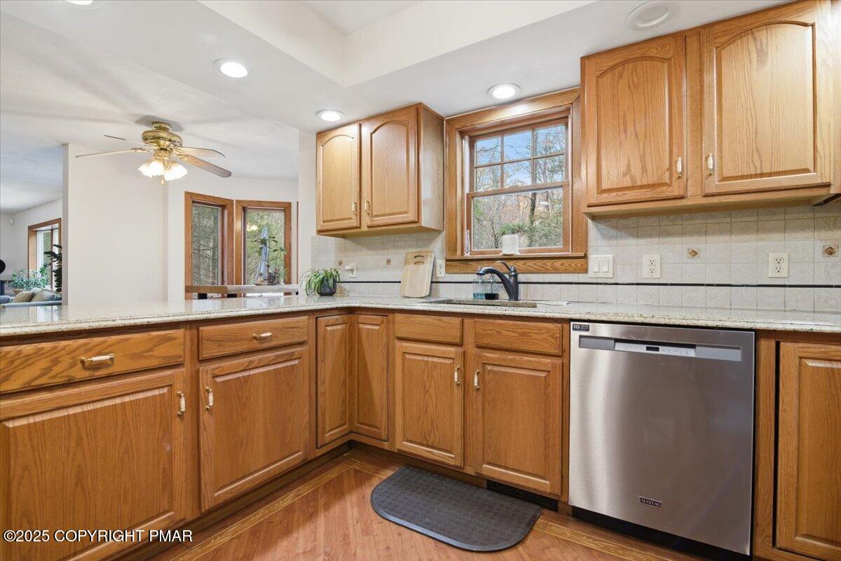 563 Pensyl Creek Road Stroudsburg, PA 18360 - Photo 26 of 143 a kitchen with stainless steel appliances granite countertop a sink a stove cabinets and wooden floor