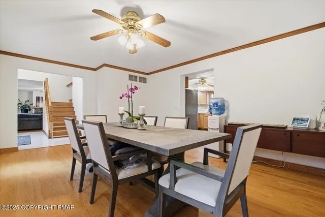 a living room with furniture and a dining table with kitchen view