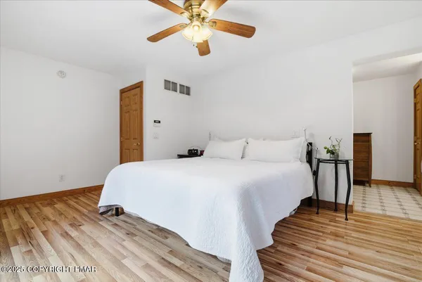 a view of empty room with wooden floor and fireplace